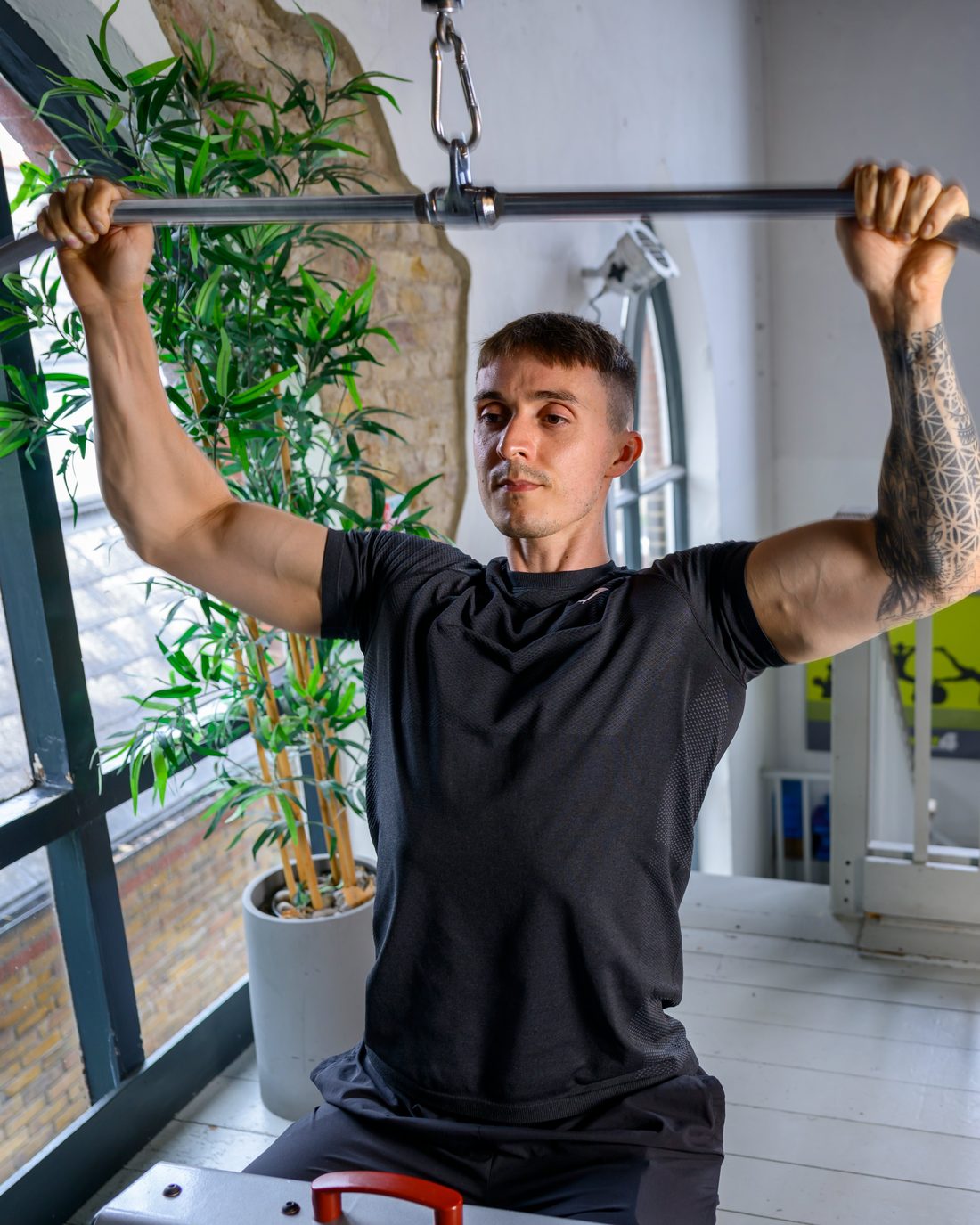 Tom demonstrating a lat pulldown at West 4 Gym