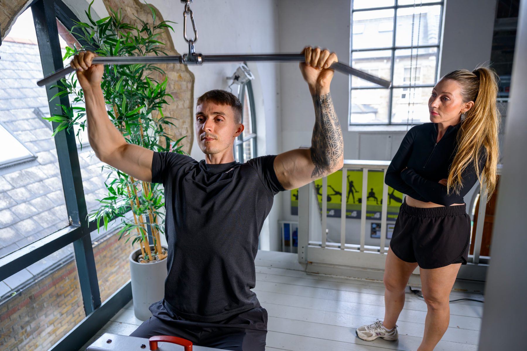 Tom demonstrating a lat pulldown for muscle building at West 4 Gym