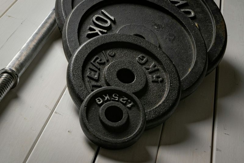 Cast iron weight plates stacked on a gym floor